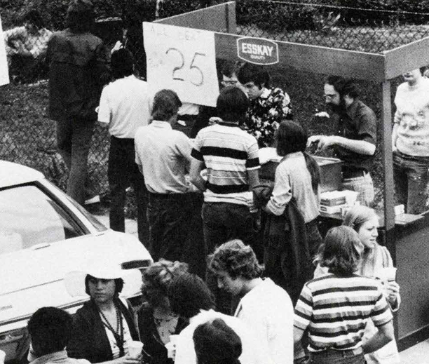 Students line up for food during a spring block party on campus