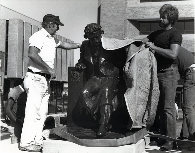 The Poe statue is unveiled after being placed on the campus commons. 