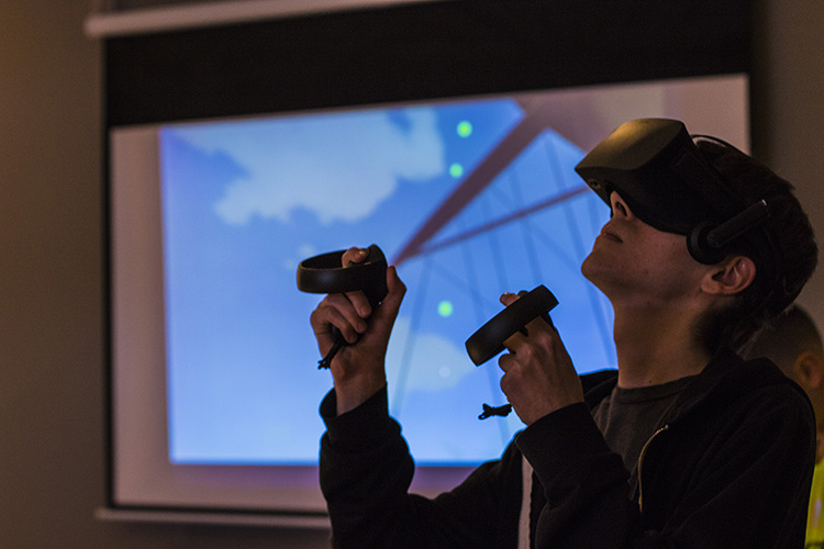 A student plays a virtual reality simulation.