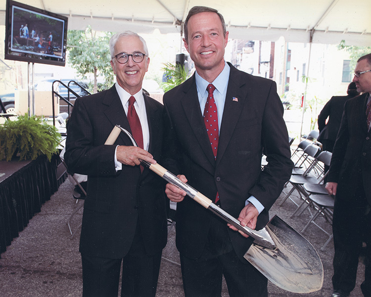 Bob Bogomolny and Martin O'Malley hold a shovel during a ceremonial groundbreaking for the new law center.