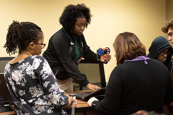 group discussing robot with professor