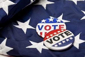 Two vote buttons on an American Flag backdrop