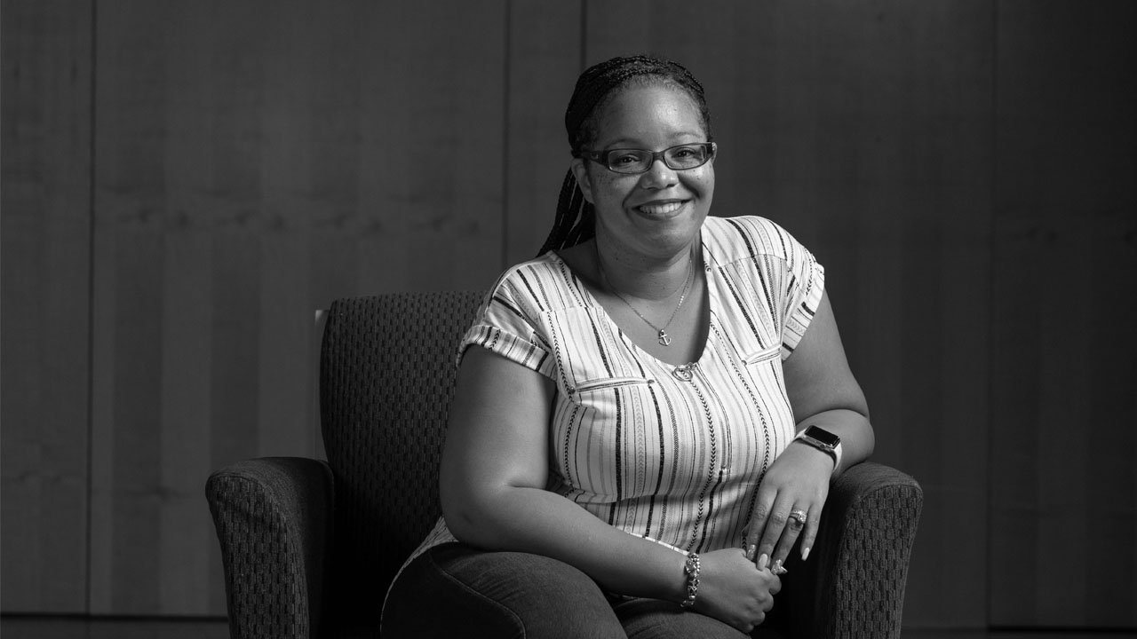 Nikki Yeboah, a UBalt alum and student, in a black and white portrait.